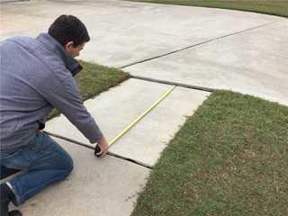 Owner, Will Blake, showing how unlevel the sidewalk is