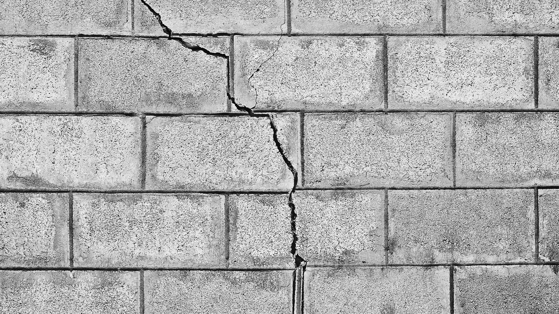 cracked concrete wall image used as a design element for website