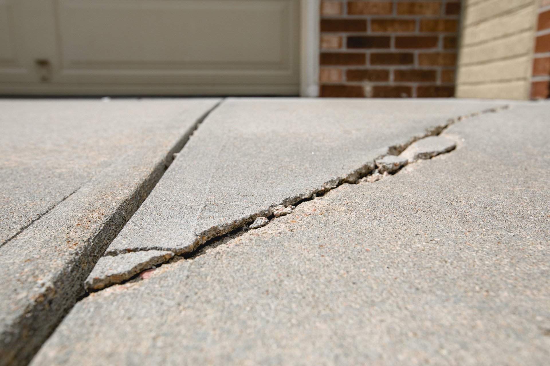 Example of cracked driveway outside garage door