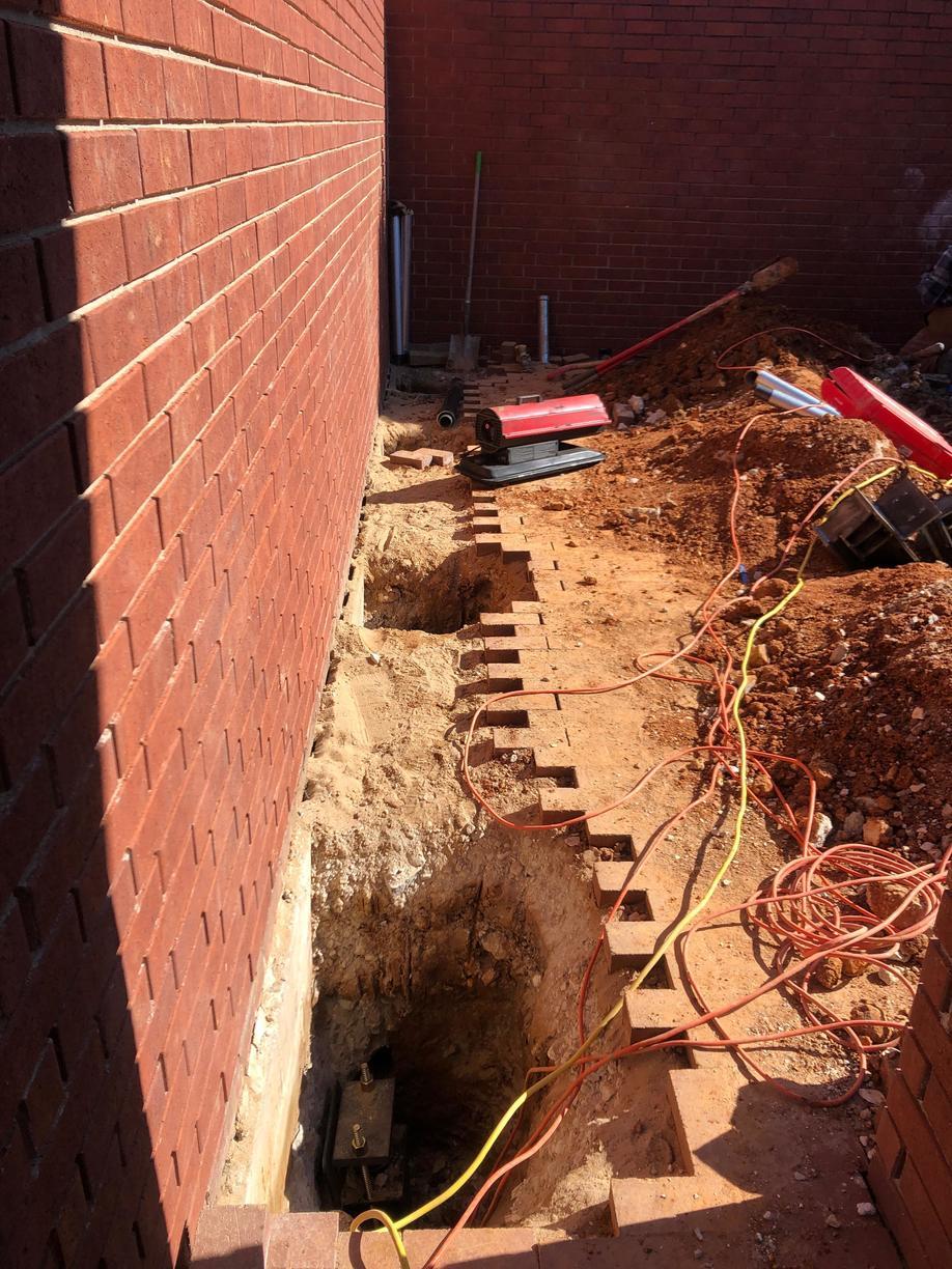 As you see here, the tops of the pier systems are visible until we lift and backfill. Helical piers and push pier systems can be hidden once backfilled.