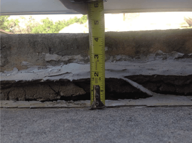 This sidewalk had settled nearly 4 inches due to the uncompacted fill beneath the slab.