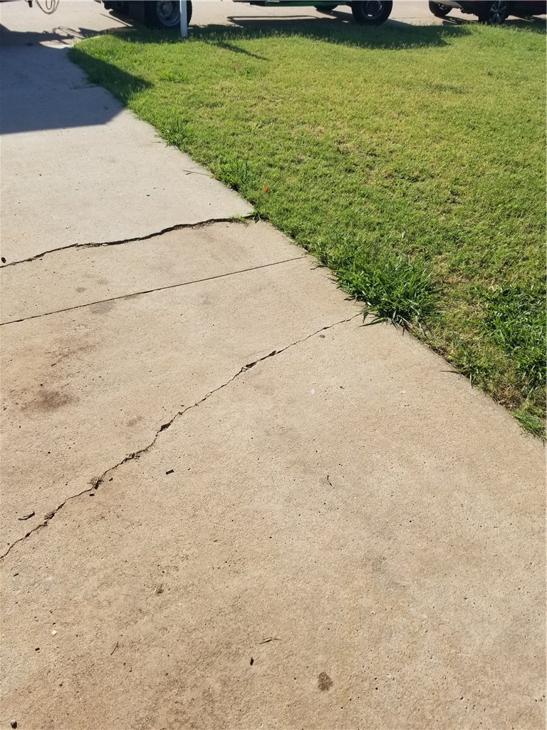Cracks like this are common on sloped driveways in Oklahoma City. These are prepared using a grinder and then the joints are sealed using Nexus Pro Crack Sealer.