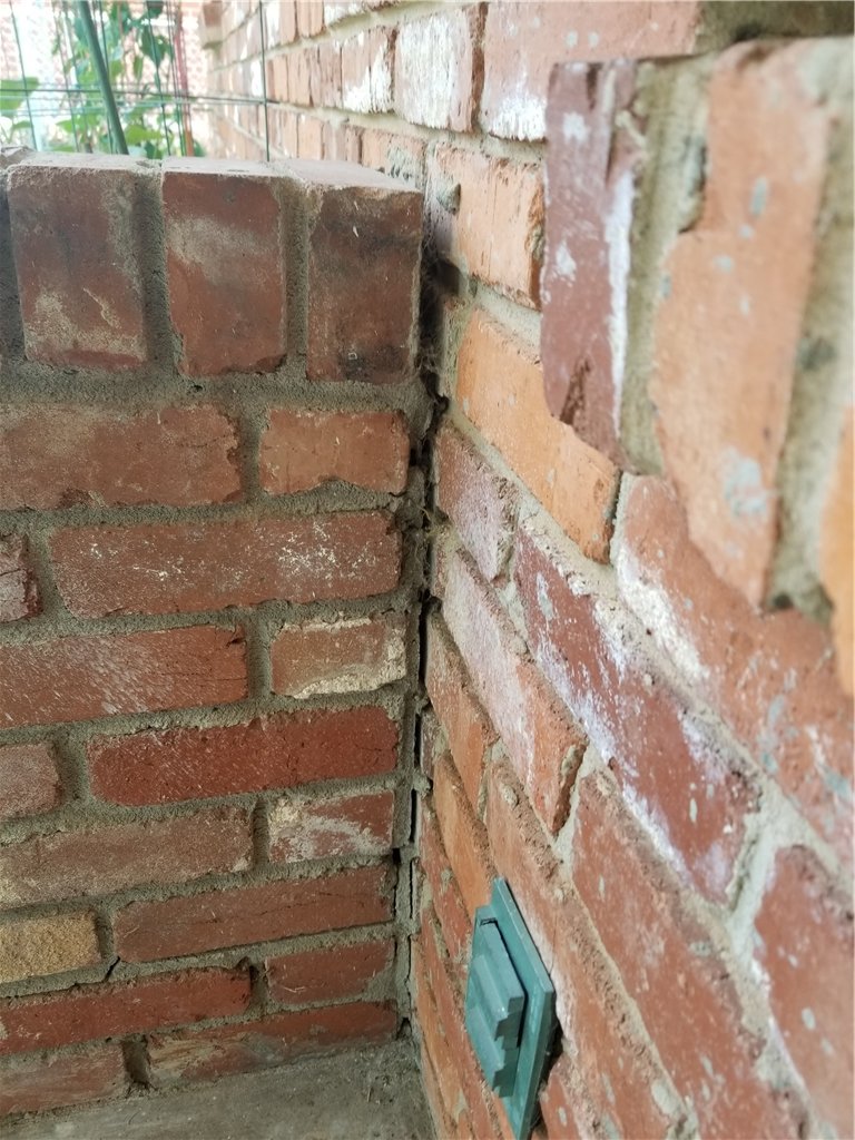 The brick wall was installed on top of the slab portion. Because of the poor compaction of soil the brick wall settled with the porch.