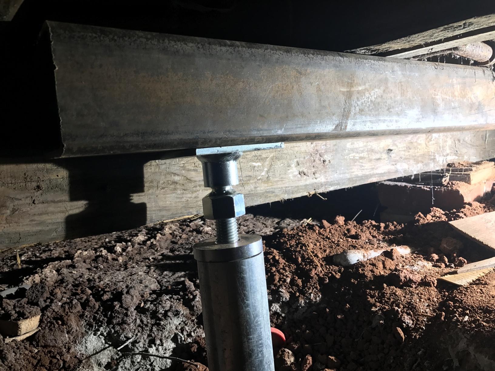 Smart Jacks were installed to lift and level the floor framing. The beams were constructed of 4inch steel tubing for strength and head clearance.