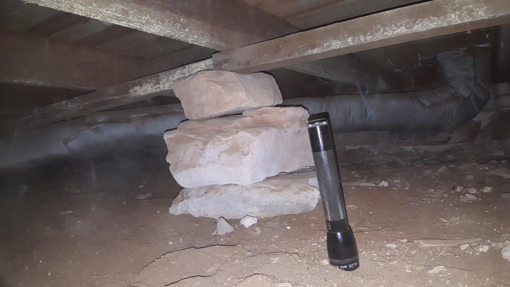 The flashlight in this picture shows the height of the crawl space nearly being about 16 inches. Even with tight locations a Smart Jack system can be easily installed.