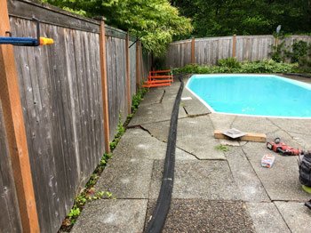 Cracked pool deck before repaired